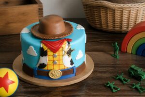 Toy Story birthday cake with characters Woody, Buzz, and others on top.